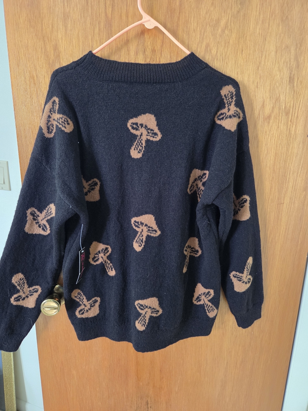 No Boundaries Black Crewneck Sweater with Tan Mushroom Motif